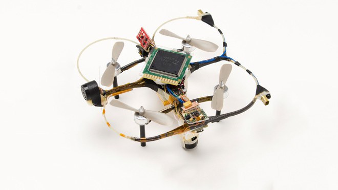 A small research quadcopter with a processor chip mounted on its frame, photographed against a white background.